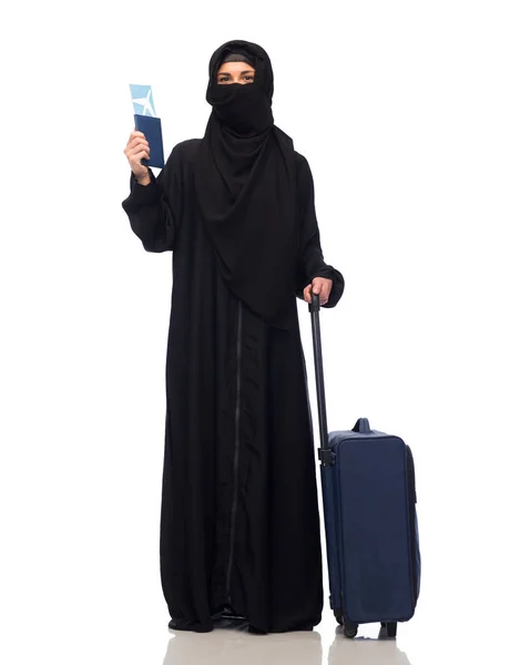 Мусульманка с билетом, паспортом и дорожной сумкой — стоковое фото