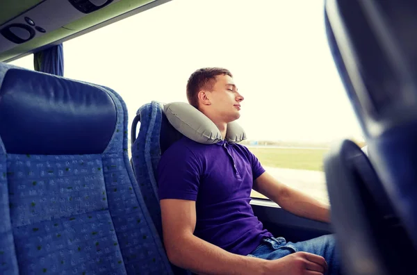 Jovem feliz dormindo em ônibus de viagem com travesseiro — Fotografia de Stock