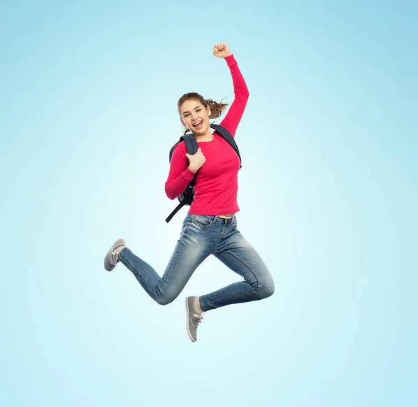 Happy woman or student with backpack jumping — Stock Photo, Image