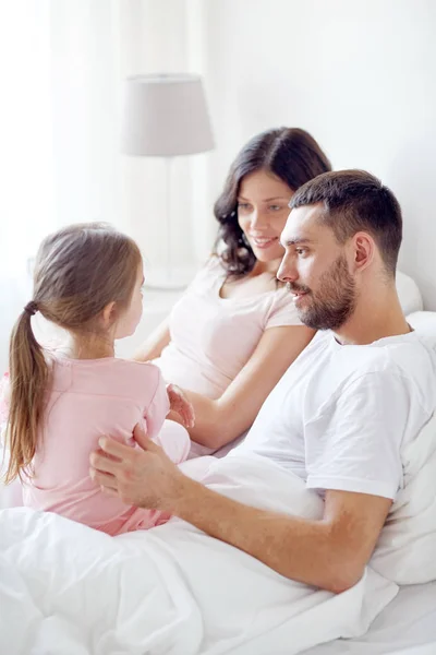 Happy family in bed at home — Stock Photo, Image