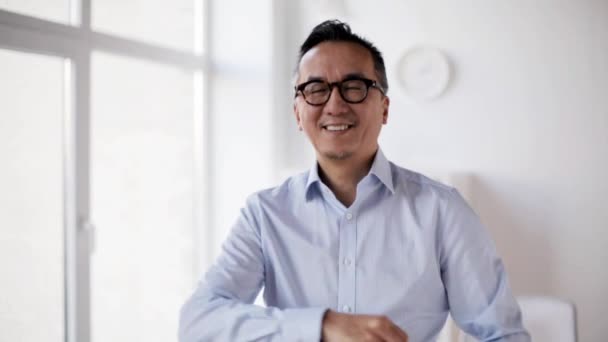 Ευτυχισμένος Ασίας επιχειρηματίας, κουνώντας το χέρι του στο γραφείο — Αρχείο Βίντεο