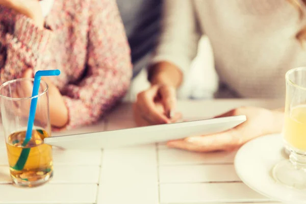 Close up of family with tablet pc at restaurant — Stock Photo, Image