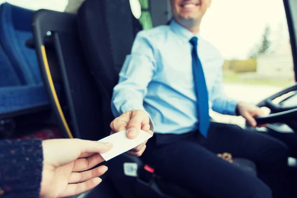 Close up of bus driver selling ticket to passenger — Stock Photo, Image