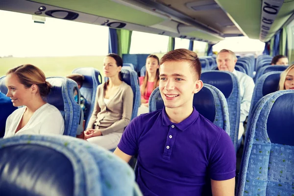 Happy young man sitting in travel bus or train — Stock Photo, Image