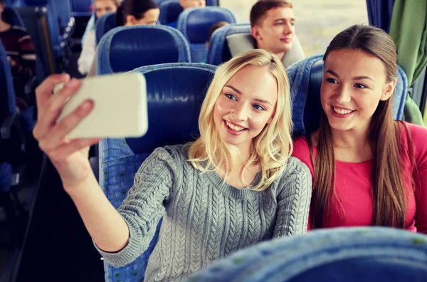 Women taking selfie by smartphone in travel bus — Stock Photo, Image