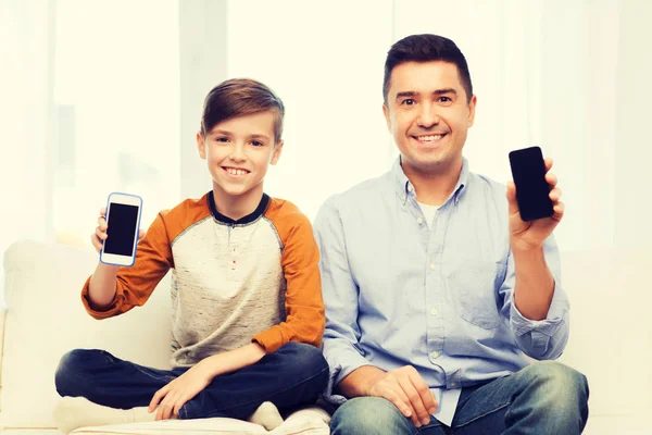 Happy father and son with smartphones at home — Stock Photo, Image
