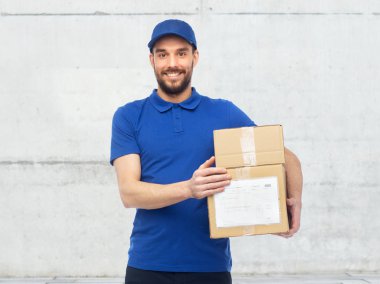 happy delivery man with parcel boxes clipart