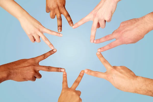group of international people showing peace sign