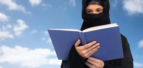 Kitap üzerinde gökyüzü okuma hijab Müslüman kadın — Stok fotoğraf