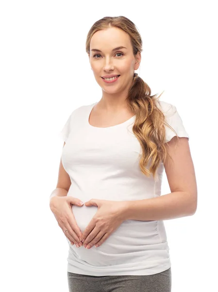 心のジェスチャーを示す幸せな妊娠中の女性 — ストック写真