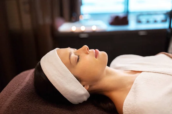 Young woman with headband lying in spa parlor — Stock Photo, Image
