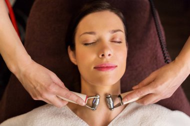 woman having hydradermie facial treatment in spa clipart
