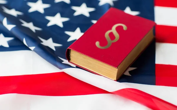 Close up of american flag and lawbook — Stock Photo, Image