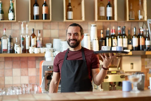 happy man or waiter with coffee and sugar at bar