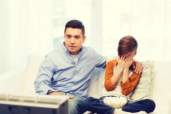 Father and son watching horror movie on tv at home — Stock Photo, Image