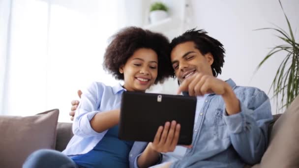 Sorrindo casal feliz com tablet pc em casa — Vídeo de Stock