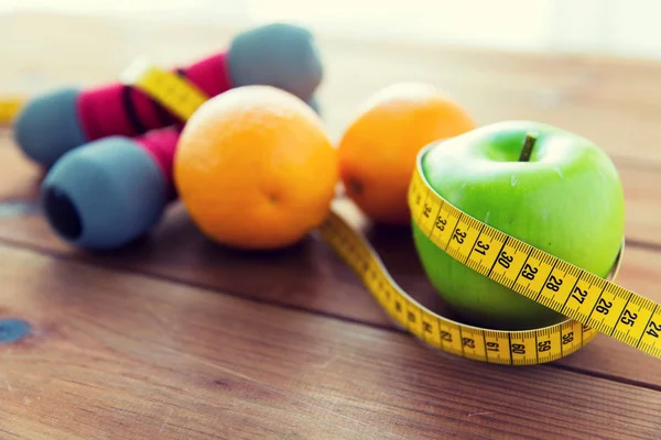 Close-up de haltere, frutas e fita métrica — Fotografia de Stock