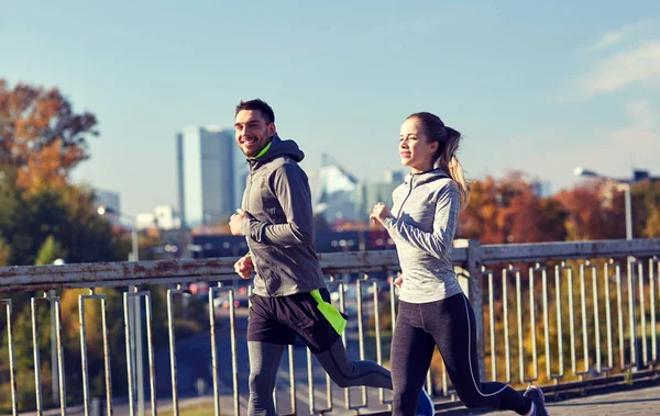 happy couple running outdoors