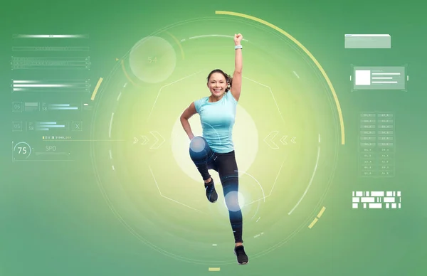 Happy smiling sporty young woman jumping in air — Stock Photo, Image