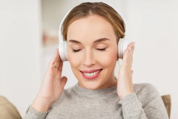 家里带耳机听音乐的女人 — 图库照片
