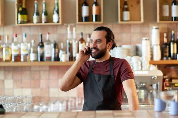 Homem feliz ou garçom no bar chamando no smartphone — Fotografia de Stock