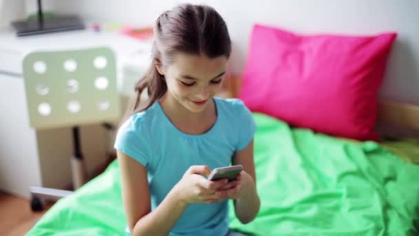 Sorridente ragazza sms su smartphone a casa — Video Stock