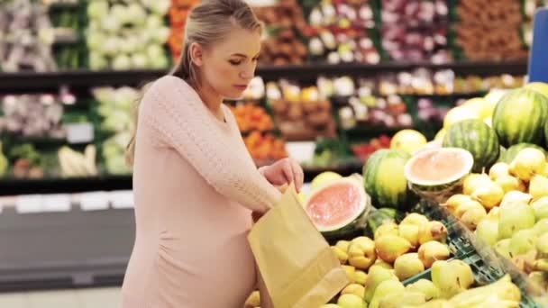 Schwangere mit Tasche kauft Birnen im Lebensmittelgeschäft — Stockvideo