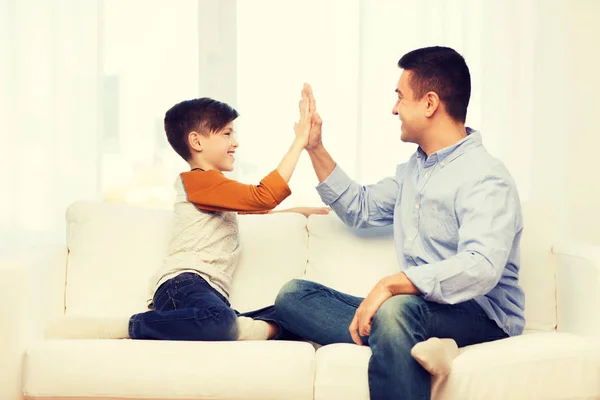 Happy father and son doing high five at home — Stock Photo, Image