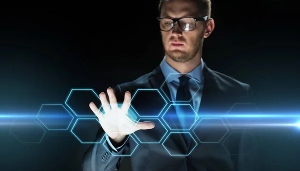 Businessman touching virtual hexagonal projection — Stock Photo, Image