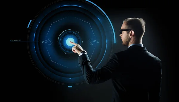 Businessman pointing finger to virtual projection — Stock Photo, Image