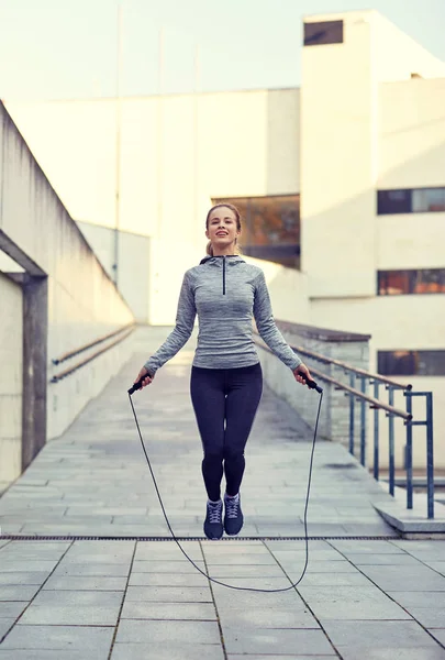 Happy woman exercising with jump-rope outdoors — Stock Photo, Image