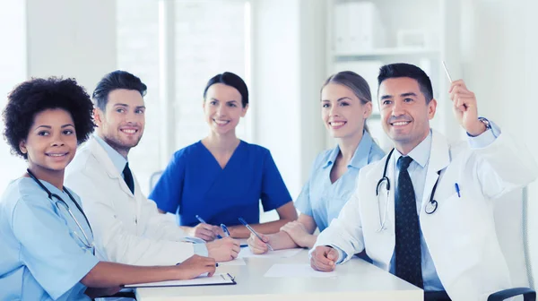 Group of happy doctors on conference at hospital — Stock Photo, Image