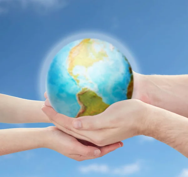 Child and father hands holding earth planet — Stock Photo, Image