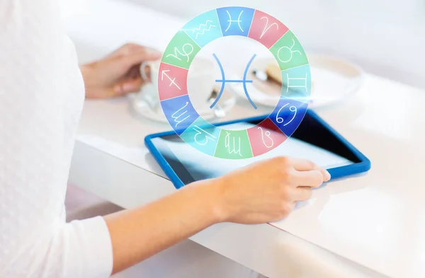 Woman with tablet pc and zodiac signs at cafe — Stock Photo, Image