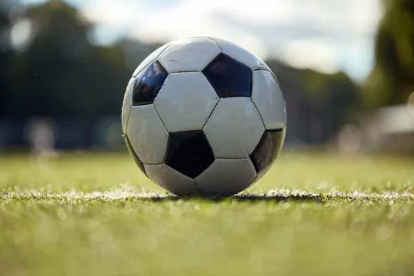 Soccer ball on football field — Stock Photo, Image