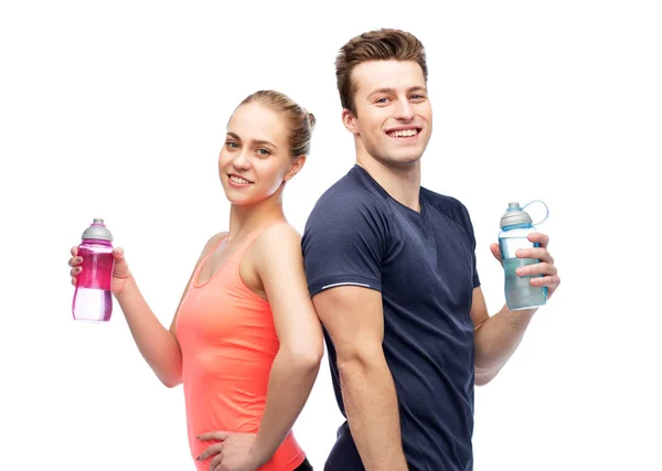 Sportive man and woman with water bottles — Stock Photo, Image