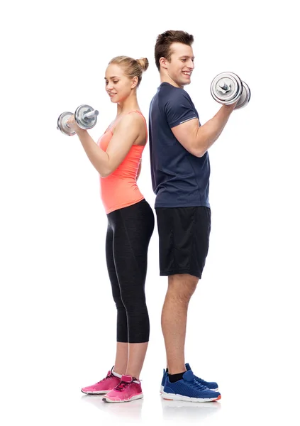 Sportive man and woman with dumbbells — Stock Photo, Image