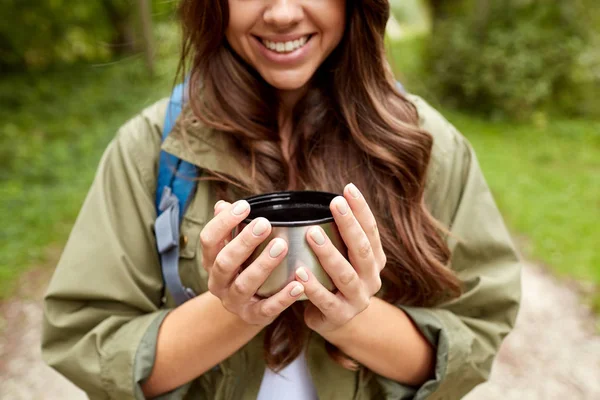 Close up of woman with cup and backpack hiking — Stock Photo, Image