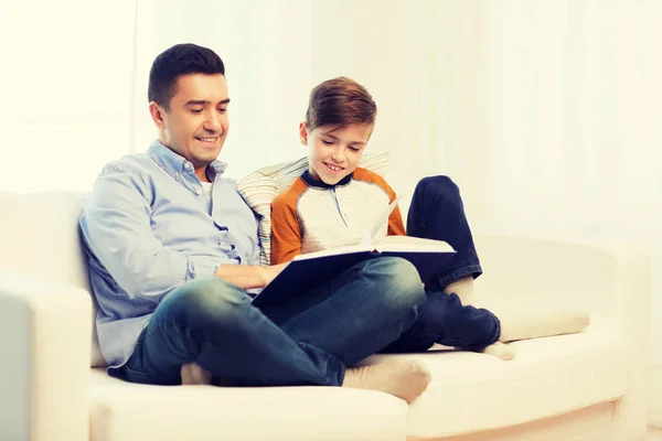 Feliz padre e hijo leyendo libro en casa —  Fotos de Stock