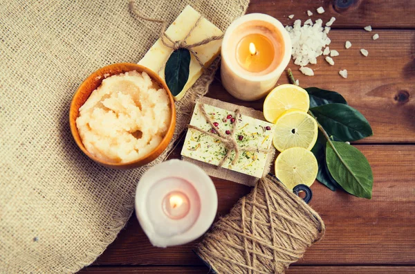 Close up of natural soap and candles on wood — Stock Photo, Image