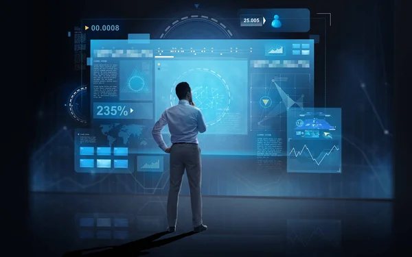 Businessman looking at virtual screens over dark — Stock Photo, Image