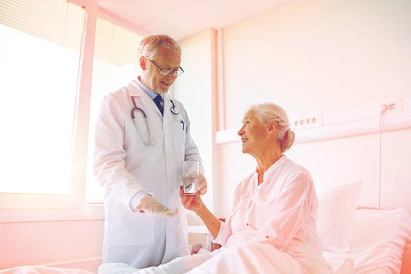 Medico che dà la medicina alla donna anziana in ospedale — Foto Stock