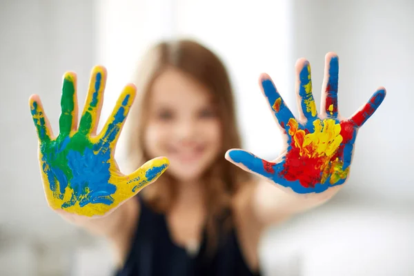 Girl showing colored hands — Stock Photo, Image
