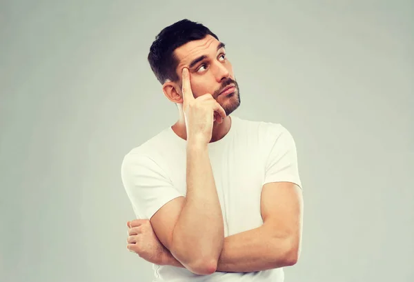 Man thinking over gray background — Stock Photo, Image