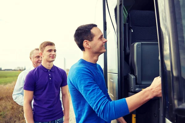 Group of happy male passengers boarding travel bus — Stock Photo, Image