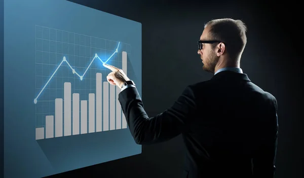 Businessman pointing finger to virtual chart — Stock Photo, Image