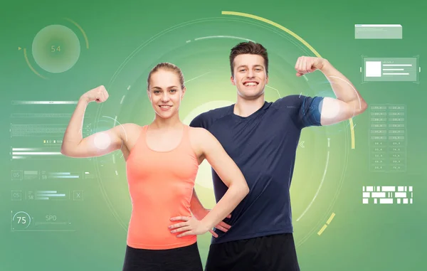 Happy sportive man and woman showing biceps power — Stock Photo, Image