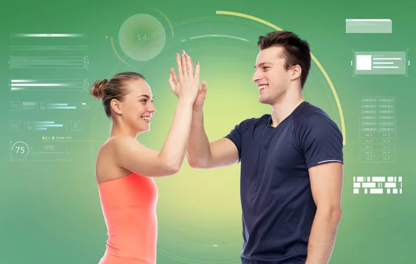 Happy sportive man and woman making high five — Stock Photo, Image