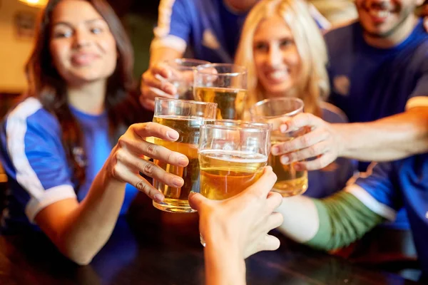 Fußballfans klirren an Sportbar mit Biergläsern — Stockfoto