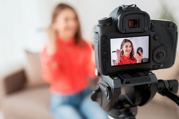 Woman with bronzer and camera recording video — Stock Photo, Image